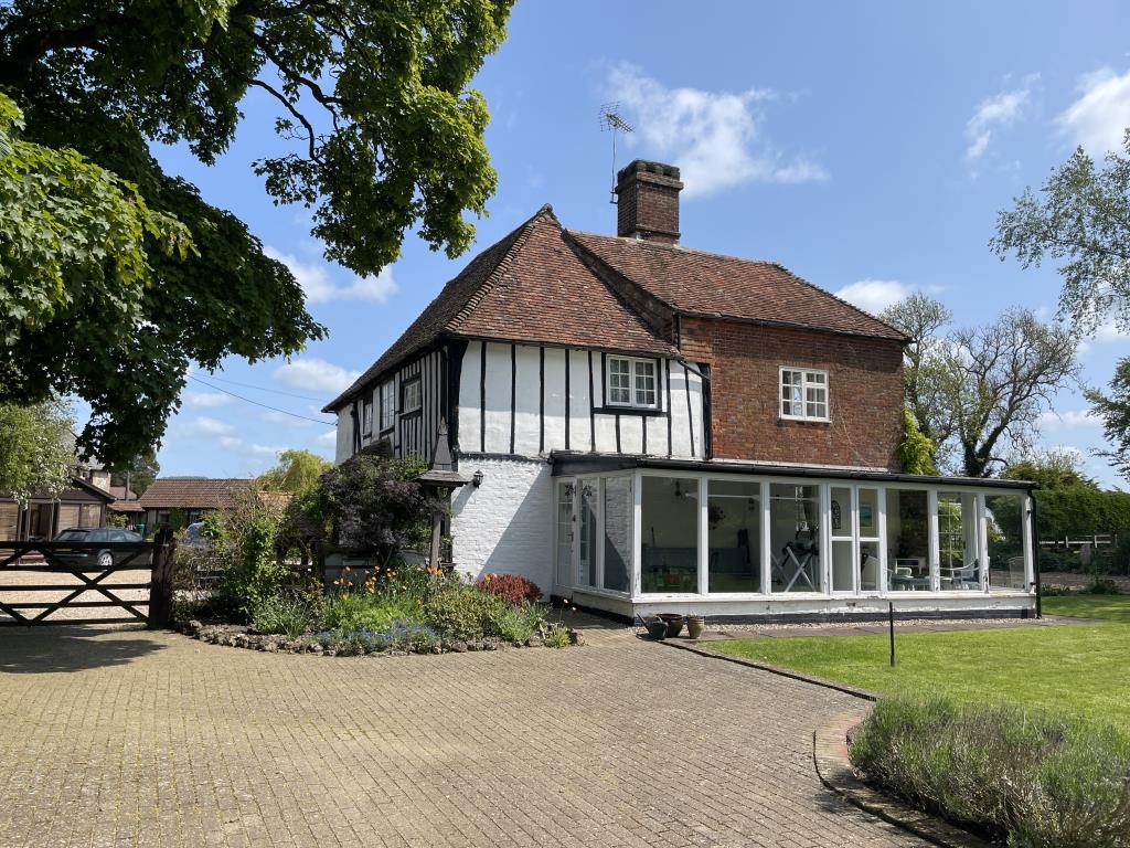 Lot: 71 - FIVE-BEDROOM HOUSE WITH SURROUNDING GARDENS AND PADDOCK IN THE SAME OWNERSHIP FOR 50 YEARS - Rear of property showing conservatory
